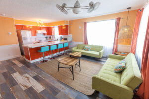 image of kitchen and seating area in two bedroom deluxe suite at Upper Deck Hotel in South Padre Island